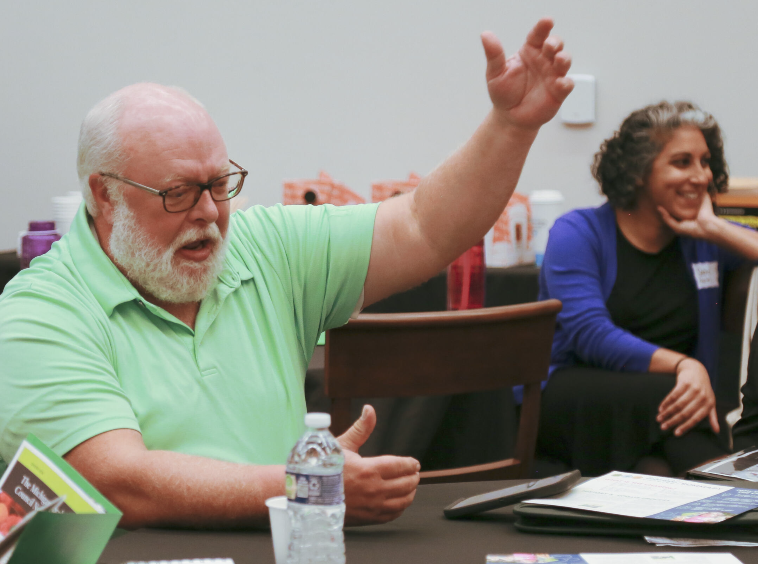 Joe Bixler raises his hand as he addresses the room.